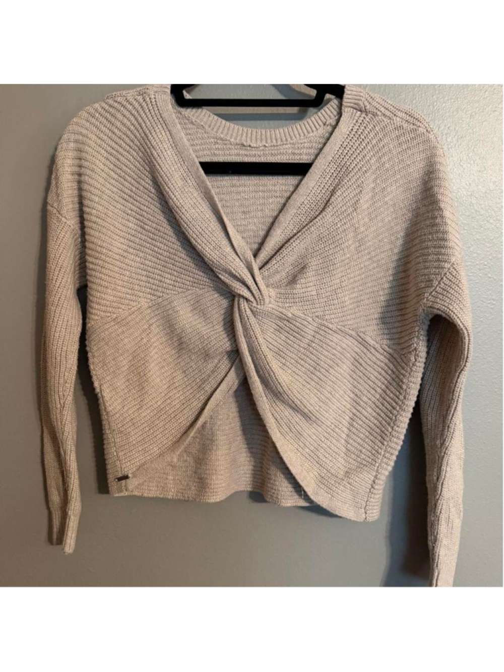 Hollister oatmeal beige knit sweater with a statement twist-front design and ope